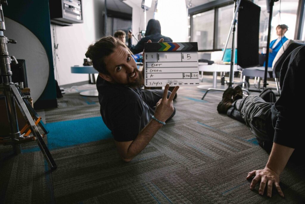 Camera operator getting a low-angle shot on set during a video production.