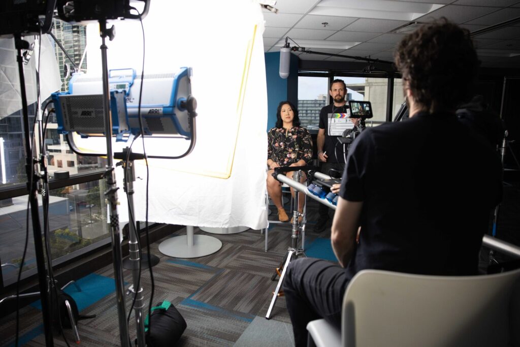 New Evolution Video crew filming on location in a modern office.