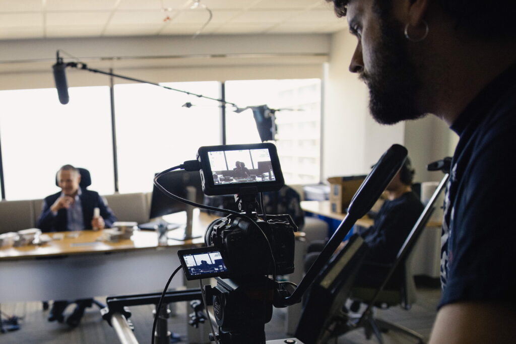 SaaS video production crew filming a software product demo in a modern office.